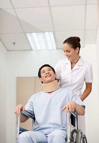 nurse wheeling patient in wheelchair