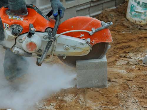 A grinder dry cuts through concrete stone creating silica dust which is dangerous to an employee's health if inhaled.